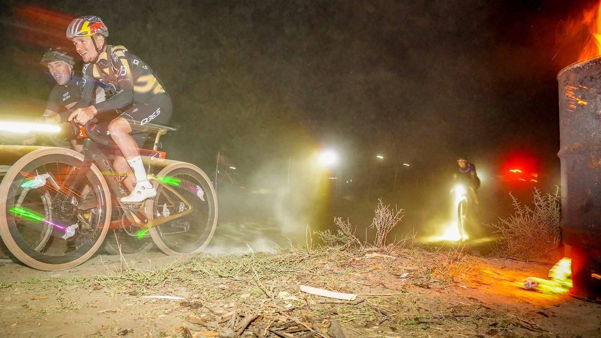 Riders racing through the dark with lights on the Night Burn circuit