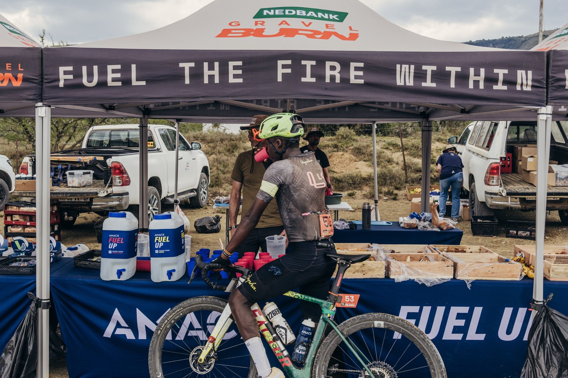 A rider at an AMACX Padstal, under a “Fuel the fire within” gazebo