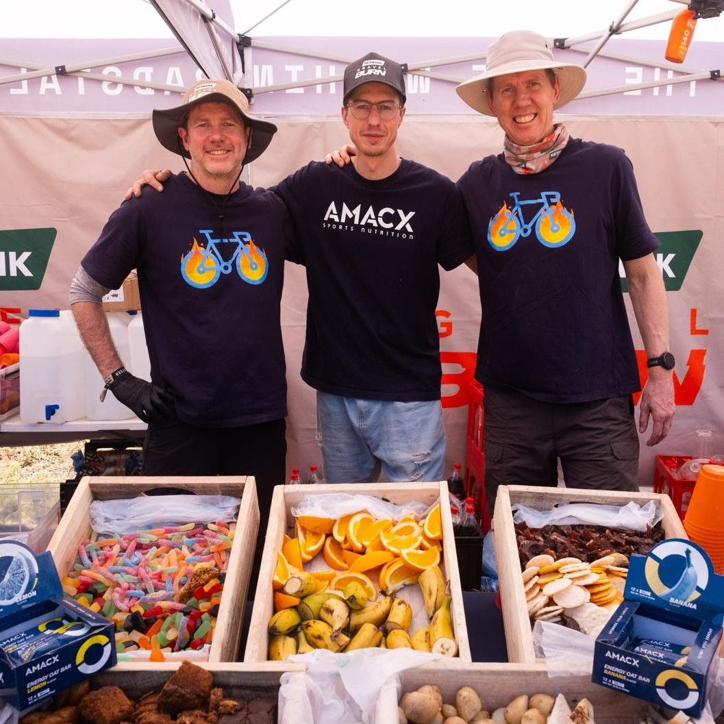 Smiling Padstal crew behind trays of fruit, sweets, boiled potatoes and AMACX energy bars