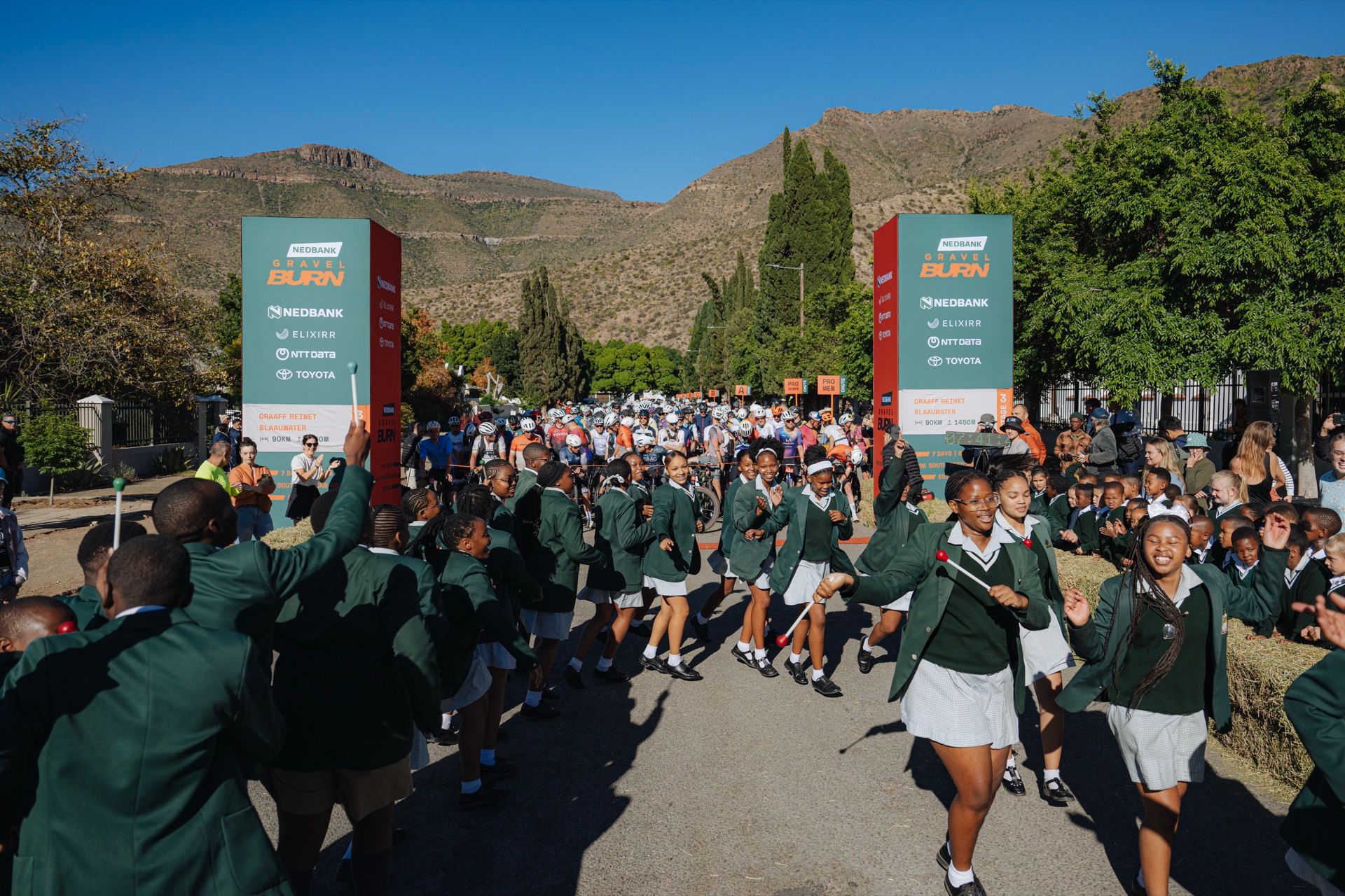 Schoolchildren cheering at the start line in Graaff-Reinet
