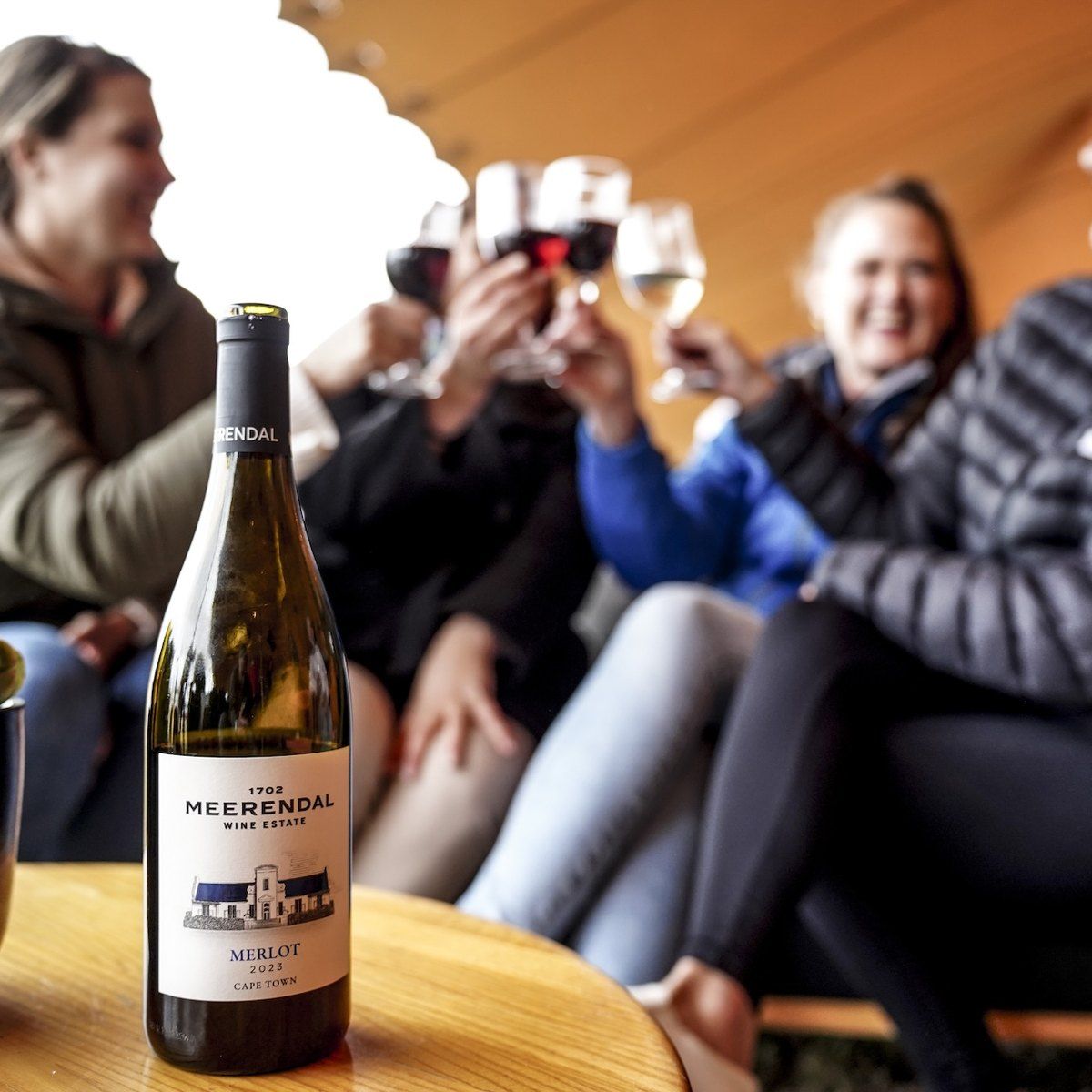 Riders raising glasses of Meerendal wine in the Burn Camp